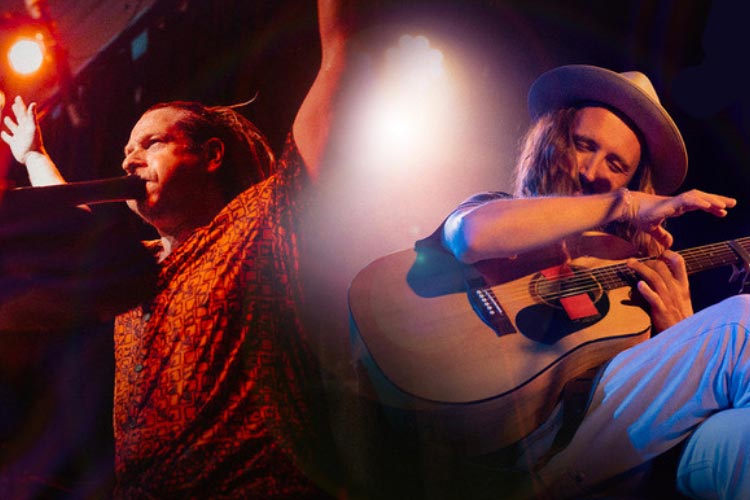A combined photo of Si Mullumby and Ben Catley performing onstage. Si is on the left in an orange patterned shirt, standing with arms raised, blowing in to a didgeridoo. Ben is on the right, seated and playing an acoustic guitar.